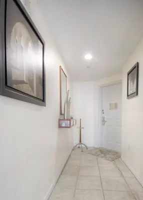 a hallway with white walls and a picture on the wall at Le Marina Bay 1109 STR-01972 in Sunny Isles Beach
