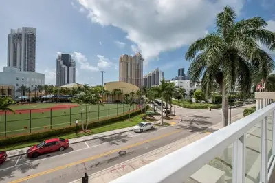 a view of a city street with cars on the road at Le Marina Bay 310 STR-01478 in Sunny Isles Beach
