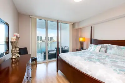 a bedroom with a bed and a view of the water at Le Marina Bay 403 STR-01408 in Sunny Isles Beach