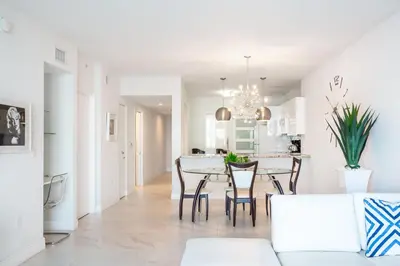 a living room and dining room with a table and chairs at Le Marina Bay 403 STR-01408 in Sunny Isles Beach