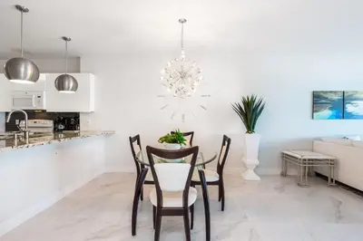a kitchen and dining room with a table and chairs at Le Marina Bay 403 STR-01408 in Sunny Isles Beach