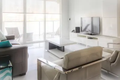 a living room with a couch and a tv at Le Marina Bay 407 STR-01404 in Sunny Isles Beach