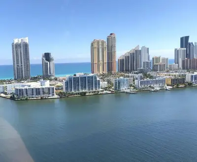 an aerial view of a city with a large body of water at Le Marina Bay 407 STR-01404 in Sunny Isles Beach