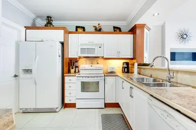 a kitchen with white appliances and a white refrigerator at Le Marina Bay 505 STR-02744 in Sunny Isles Beach