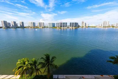 a large body of water with palm trees and buildings at Le Marina Bay 603 STR-02736 in Sunny Isles Beach
