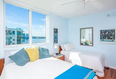 two beds in a room with a window at Le Marina Bay 801 STR-01477 in Sunny Isles Beach