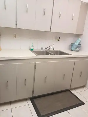 a kitchen with white cabinets and a sink at Le Marbella 303 STR-02828 in Sunny Isles Beach