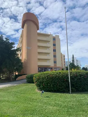 a building with a bird in the grass in front of it at Marbella Tower 706 STR-02489 in Sunny Isles Beach