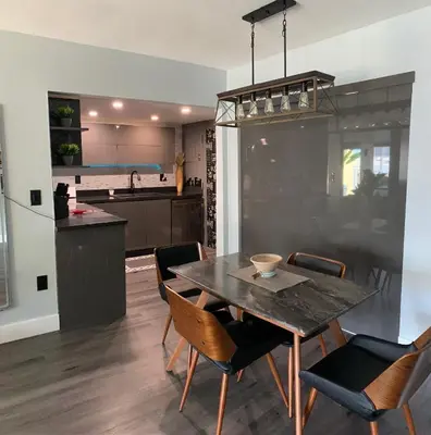 a kitchen and dining room with a table and chairs at Marbella Tower 706 STR-02489 in Sunny Isles Beach