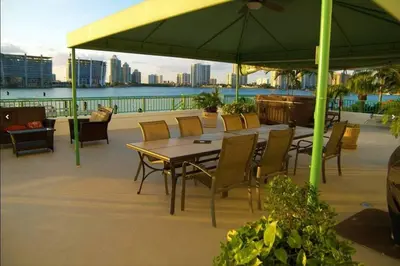 a patio with a table and chairs and an umbrella at Le Montcalm 102 STR-01921 in Sunny Isles Beach