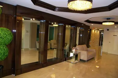 a person sitting in a chair in a lobby at Le Montcalm 102 STR-01921 in Sunny Isles Beach