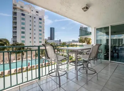 a balcony with a table and chairs and a pool at Le Montcalm 303 STR-01919 in Sunny Isles Beach