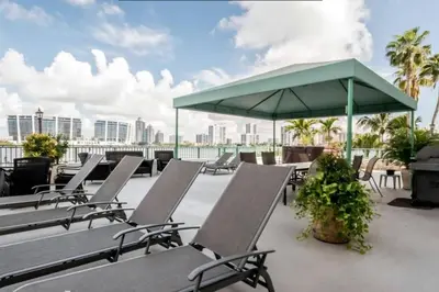 a group of chairs and an umbrella on a roof at Le Montcalm 303 STR-01919 in Sunny Isles Beach