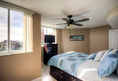 a bedroom with a ceiling fan and a bed at Le Montcalm 601 STR-01927 in Sunny Isles Beach