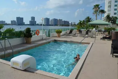 a woman in a swimming pool on a hotel at Le Montcalm 601 STR-01927 in Sunny Isles Beach