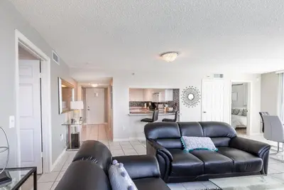 a living room with a leather couch and a table at Le Montcalm 804 STR-01923 in Sunny Isles Beach