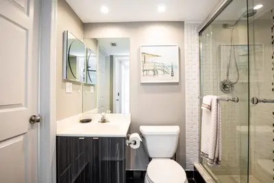 a bathroom with a toilet and a sink and a shower at Le Montcalm 804 STR-01923 in Sunny Isles Beach