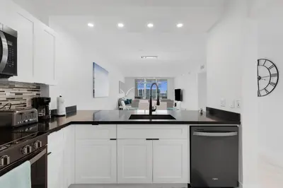 a white kitchen with a sink and a stove at Le Marina Bay PH3 STR-01487 in Sunny Isles Beach
