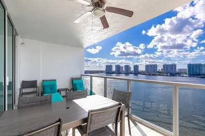 a dining room with a view of the water at Le Marina Bay PH4 STR-01484 in Sunny Isles Beach