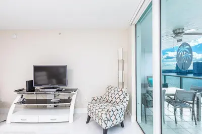 a living room with a tv and a chair at Le Marina Bay PH4 STR-01484 in Sunny Isles Beach