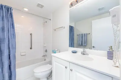 a white bathroom with a sink and a toilet at Le Marina Bay PH4 STR-01484 in Sunny Isles Beach