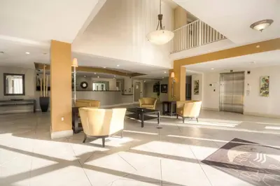 a lobby with chairs and a table in a building at Le Marina Bay PH4 STR-01484 in Sunny Isles Beach