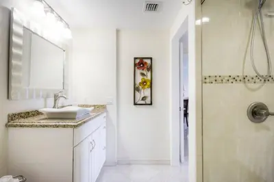 a white bathroom with a sink and a shower at Le Marina Bay PH5 STR-01500 in Sunny Isles Beach