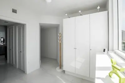 a room with white walls and a large white cabinet at Le Marina Bay 810 STR-01434 in Sunny Isles Beach