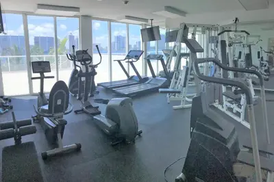a gym with several treadmills and elliptical machines at Le Marina Bay 810 STR-01434 in Sunny Isles Beach