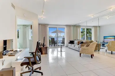 a living room with a couch and a desk with a computer at Les Pelicans #316 STR-02743 in Sunny Isles Beach