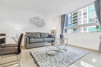 a living room with a couch and a table at Modern 2-BD Condo in Midtown Miami Pool & Gym in Miami