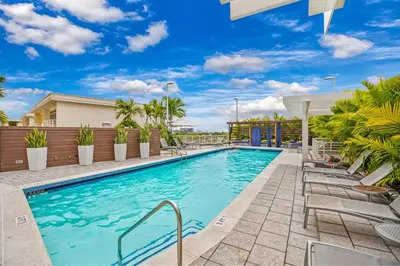 a swimming pool with chaise lounge chairs on a resort at Modern 2-BD Condo in Midtown Miami Pool & Gym in Miami