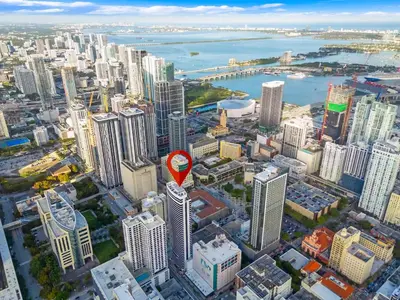 an aerial view of a city with a red sign on top at District 225 in Miami