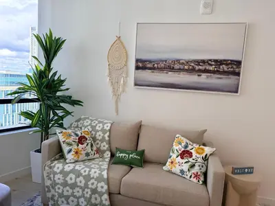 a living room with a couch and a picture on the wall at District 225 in Miami
