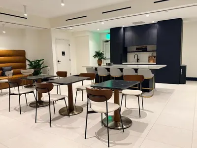 a restaurant with tables and chairs and a kitchen at District 225 in Miami