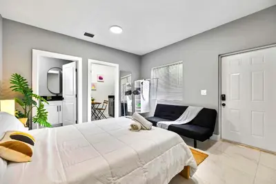 a bedroom with a large bed and a couch at Comfy Studio W Essentials Near Airport in Miami