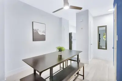 a dining room with a table and a ceiling fan at Bright 1BR Miami Beach Apt with 3 Queens & Smart TV in Miami Beach