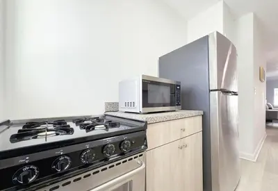 a kitchen with a stove and a microwave at 1BR Miami Beach Apt with King plus 2 Queens & Smart TV in Miami Beach