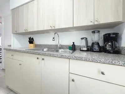 a kitchen counter with a sink and a blender at 1BR Miami Beach Apt with King plus 2 Queens & Smart TV in Miami Beach