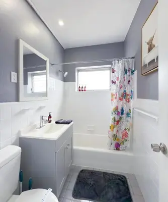 a bathroom with a sink toilet and a shower curtain at 1BR Miami Beach Apt with King plus 2 Queens & Workspace in Miami Beach