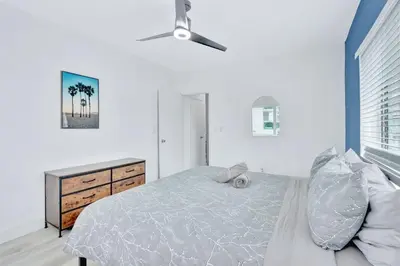 a bedroom with a bed and a ceiling fan at 1BR Miami Beach Apt with King plus 2 Queens & Workspace in Miami Beach