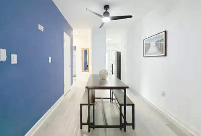 a dining room with a table and a ceiling fan at 1BR Miami Beach Apt with 3 Queens plus Free Parking in Miami Beach