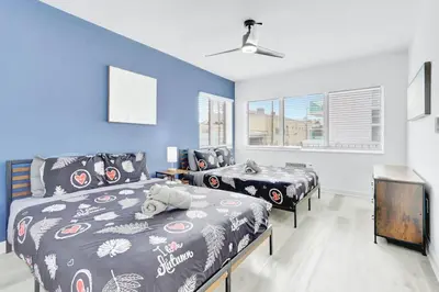 a bedroom with two beds and a tv in it at 1BR Miami Beach Apt with 3 Queens plus Free Parking in Miami Beach