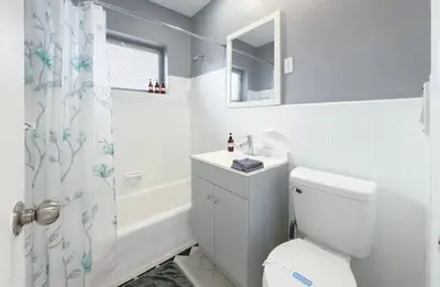 a bathroom with a toilet and a sink and a shower at 1BR Miami Beach Apt with 3 Queens plus Free Parking in Miami Beach