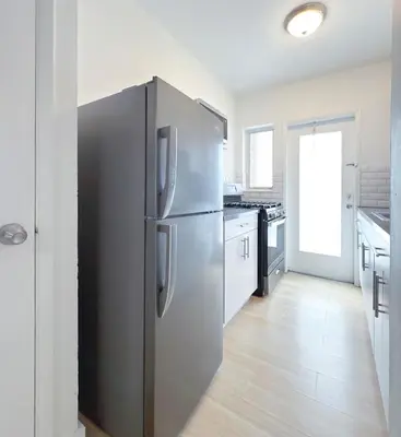 a large stainless steel refrigerator in a kitchen at 1BR Miami Beach Apt with King plus 2 Queens & Parking in Miami Beach