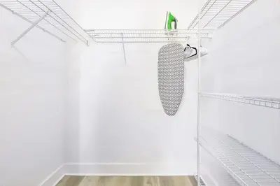 a white shower with a tie on a shelf at Modern Miami Beach Studio with King Bed in Miami Beach