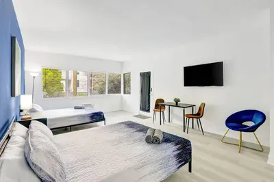 a bedroom with a bed and a tv in it at Bright 1BR Miami Beach Stay Near the Ocean in Miami Beach