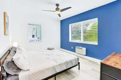 a bedroom with a bed and a blue wall at Bright 1BR Miami Beach Stay Near the Ocean in Miami Beach