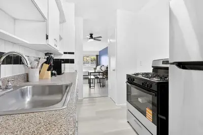 a kitchen with a sink and a stove at Sunny Miami Beach Studio with 2 Queens plus Workspace in Miami Beach