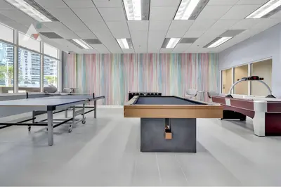 a large room with two ping pong tables at Sky-High Luxury 3BR with Stunning Brickell City & Bay Views in Miami